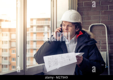 Construction Engineer Using Cell Mobile Phone. Soft focus, toned. Stock Photo