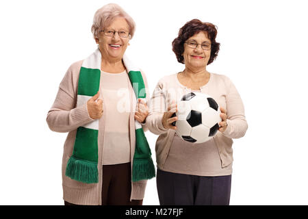 Elderly female soccer fans with a scarf and a football isolated on white background Stock Photo