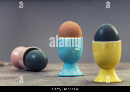 Dark Painted Easter Eggs in Cups Stock Photo