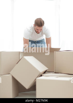 male sorting things in the new apartment. Stock Photo