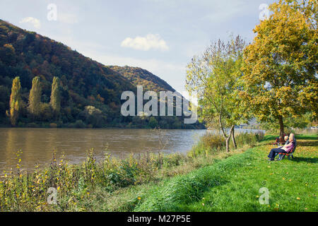 Eldery people sitting on a bench at riverside of Moselle river, Ediger, Ediger-Eller, Moselle river, Rhineland-Palatinate, Germany, Europe Stock Photo