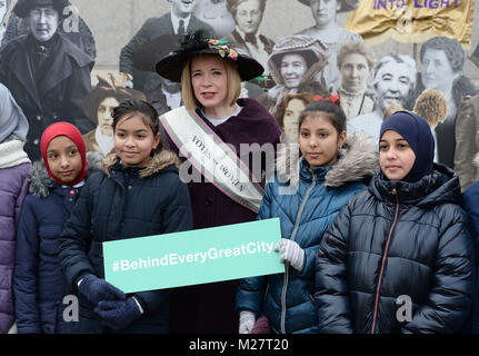 Curator of the Historic Royal Palaces Lucy Worsley with children from Milbank Academy at the opening of an exhibition in Trafalgar Square, London to mark the centenary of womens suffrage. Stock Photo