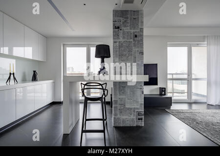 Modern black and white interior with magazine themed wallpaper