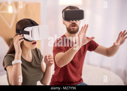 Positive attractive couple exploring VR Stock Photo