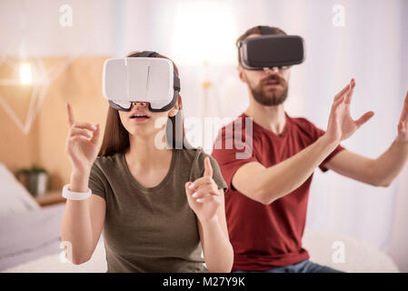 Speechless cute couple wondering in VR Stock Photo
