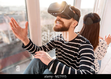 Shocked inspired man strolling in VR Stock Photo