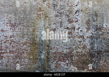 Vintage brick wall with peeling paint and rust Stock Photo