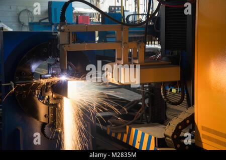 automatic laser machine cuts metal profile, close-up. pipe cutting system Stock Photo