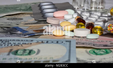 a bunch of pills of different colors on a dollars, blurry photos Stock Photo
