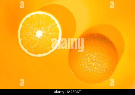 Two oranges on orange background. Art food concept Stock Photo