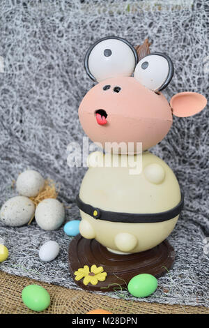 chocolate egg in the shape of a lamb with various decorations Stock Photo