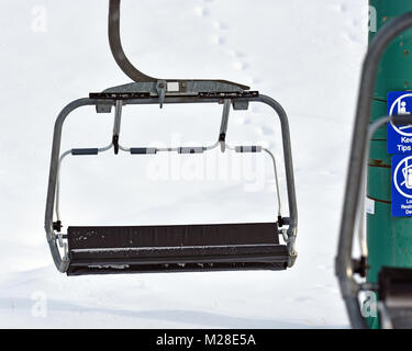 Chair lift at base of mountain with white background Stock Photo