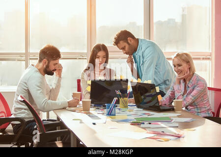 Team of creative designers working on a common project in a design studio. Skilled creative designers working on visualization great idea for interior Stock Photo