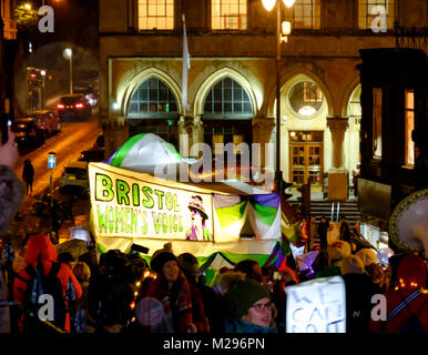 Bristol, UK. 6th Feb, 2018. The centenary of the Representation of the People Act 1918 which gave women over 30 the right to vote was celibrated tonight with a lantern parade through Bristol. Around a 1000 people turned out on a wet, snowy February night, many brought home made lanterns. Slogans promoting equal rights and pay were on many of the lanterns, reflecting that full equal rights still have to be fought for. Giant sufragette puppets,drums and a band added to the celebration. Credit: Mr Standfast/Alamy Live News Stock Photo