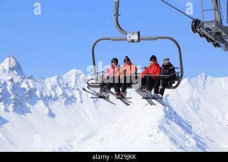 VALLOIRE, FRANCE - MARCH 23, 2015: Skiers go up the lift in Galibier-Thabor station in France. The station is located in Valmeinier and Valloire and h Stock Photo