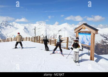 VALLOIRE, FRANCE - MARCH 24, 2015: Skiers analyze ski map in Galibier-Thabor station in France. The station is located in Valmeinier and Valloire and  Stock Photo