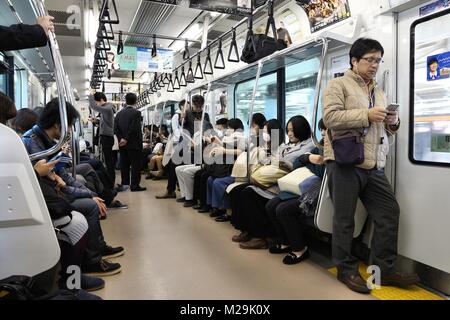 TOKYO, JAPAN - DECEMBER 3, 2016: People ride JR East Train in Tokyo. East Japan Railway Company employs more than 70,000 people. Stock Photo
