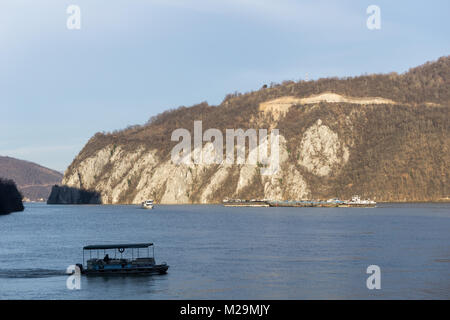 Orsova, Romania - 01.01.2018: Large and small vessels on the Danube river near its gorge Stock Photo