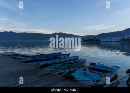 Small paddle boats tied to a pontoon on the river Danube in the town of Orsova Stock Photo