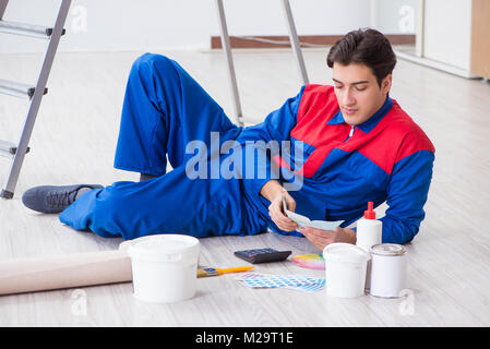 Young painter trying to match colours for painting job Stock Photo