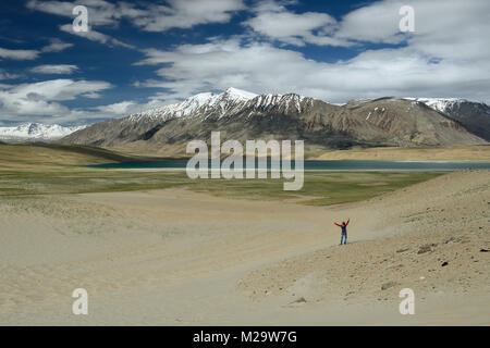 Traveller photographing the Tso Kyagar Lake in the Karakorum Mountains near Leh, India. This region is a purpose of motorcycle expeditions Stock Photo