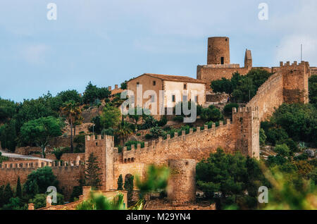 Capdepera castle on green hill in Mallorca island, Spain. Beautiful landscape with medieval architecture in Majorca Stock Photo