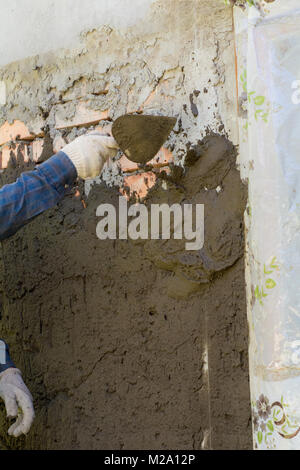 In Ukraine, most people plaster walls with their hands without automatic machines Stock Photo