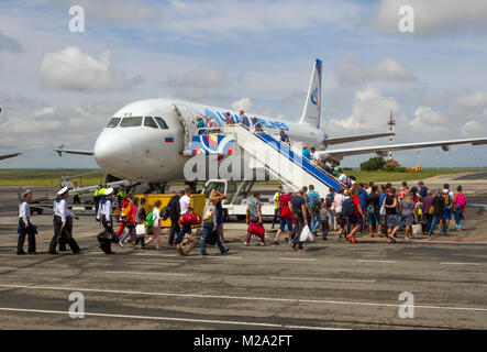 Simferopol, Russia - June 15, 2016: Passengers go on board the aircraft of airline 'Ural Airlines' for the airfield airport of Simferopol, Crimea Stock Photo