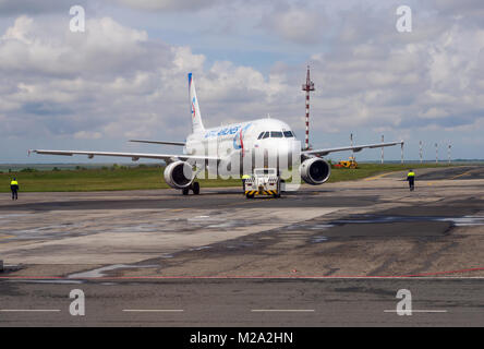 Simferopol, Russia - June 15, 2016: Airplane airline 'Ural Airlines' towed to the runway Simferopol Airport Stock Photo
