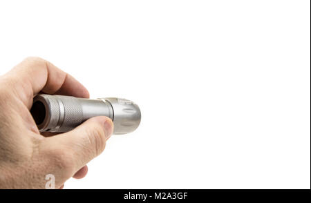 Small home pocket led flashlight in hand on the white Stock Photo