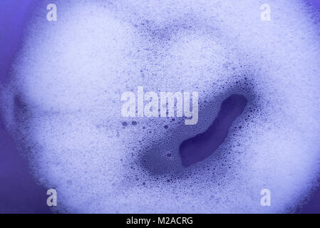 Soap bubbles against a purple background. Stock Photo