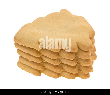 A stack of several freshly baked tree shaped Christmas cookies isolated on a white background. Stock Photo