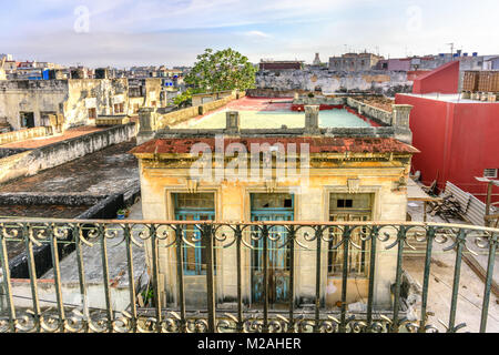 View from the balcony on the roofs of old, dilapidated, flaky buildings and a gray-blue sky in the slums area in Havana in Cuba Stock Photo