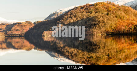 Lake District Fells reflected in the still waters of Thirlmere Reservoir, shortly after dawn in early February 2018. Stock Photo