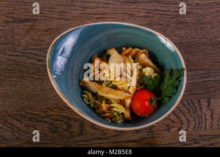 Pasta with chicken served tomato and parsley Stock Photo