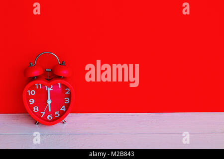 Close up red alarm clock mark at 6 o'clock in the morning Stock Photo