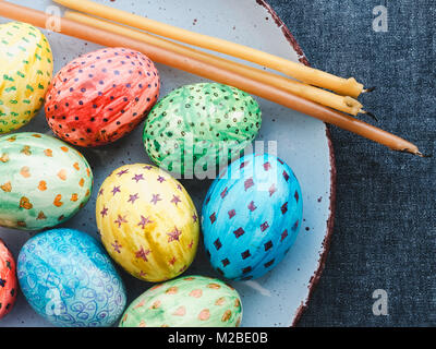 Easter eggs, painted with bright colors and candles Stock Photo