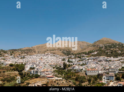 An image of the town of Competa situated at 638 meters above sea level in the foothills of La Maroma the highest peak of the Sierra Tejeda . Stock Photo