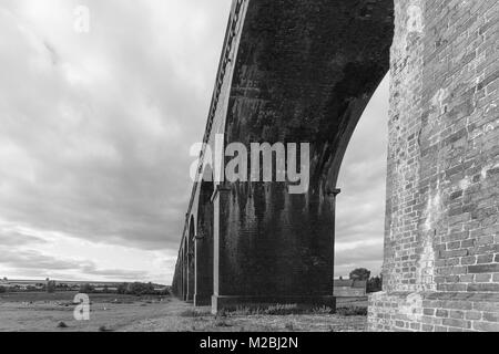 Under one of the 82 arches of Harringworth viaduct,showing the size and scale of this wonderful structure. In Black and White. Stock Photo