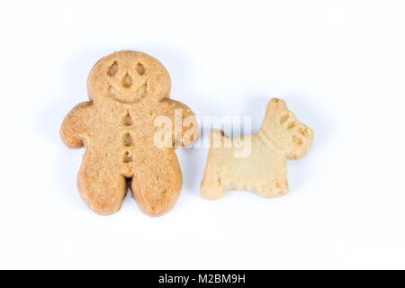 group of gingerbread man standing together with their scotty dog on a white background Stock Photo