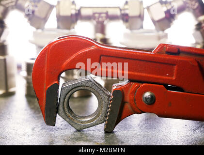 Adjust wrench power grip and elements of water and gas shutoff valves Stock Photo