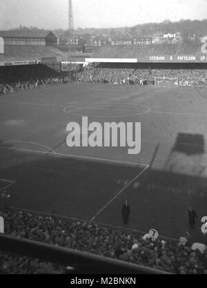 1960s, historical picture showing the packed football ground of Norwich FC before a match, taken from the television gantry overlooking the stadium and surrounding area, Norwich, England, UK. An advert for one of the club's sponsor's, the local brewery 'Stewart & Patteson Ltd' can be seen at the far end of the pitch. Stock Photo