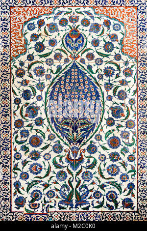 Ornate Ottoman-style ceramic tiles featuring intricate floral patterns and geometric designs in vibrant blue, green, and orange hues, r Stock Photo