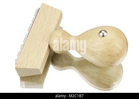 Wooden stamp against white background with reflection Stock Photo