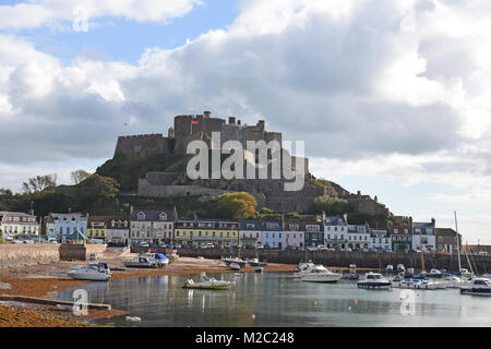 Mont Orgueil or Gorey Castle a Castle in Saint Martin Jersey with Gorey Bay at low tide with boats moored in the bay. Stock Photo