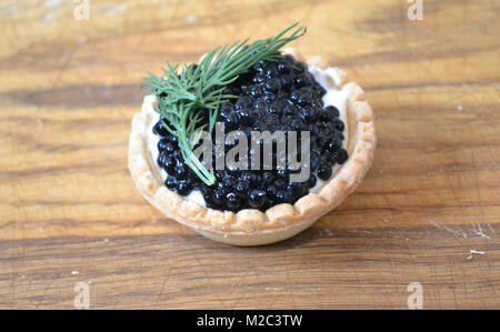 Tartlet with black caviar Stock Photo