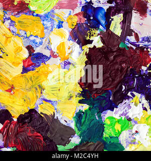Bright palette of artist, texture of mixed oil paints in different colors, mix spots, blots, texture for a modern creative background Stock Photo