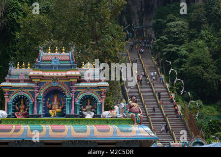 Kuala Lumpur, Malaysia - November 3, 2014: Statues of Hindu gods on the roof of the temple next to Stair, leading to the top Batu Caves - complex of c Stock Photo