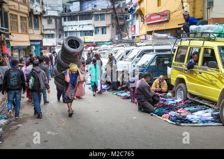Man carrying tyres on his back, Shillong, Meghalaya, India Stock Photo