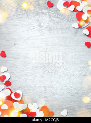 Beautiful romantic frame. Decorative red and white hearts on wooden background. View from above. Love and St. Valentines Day concept Stock Photo